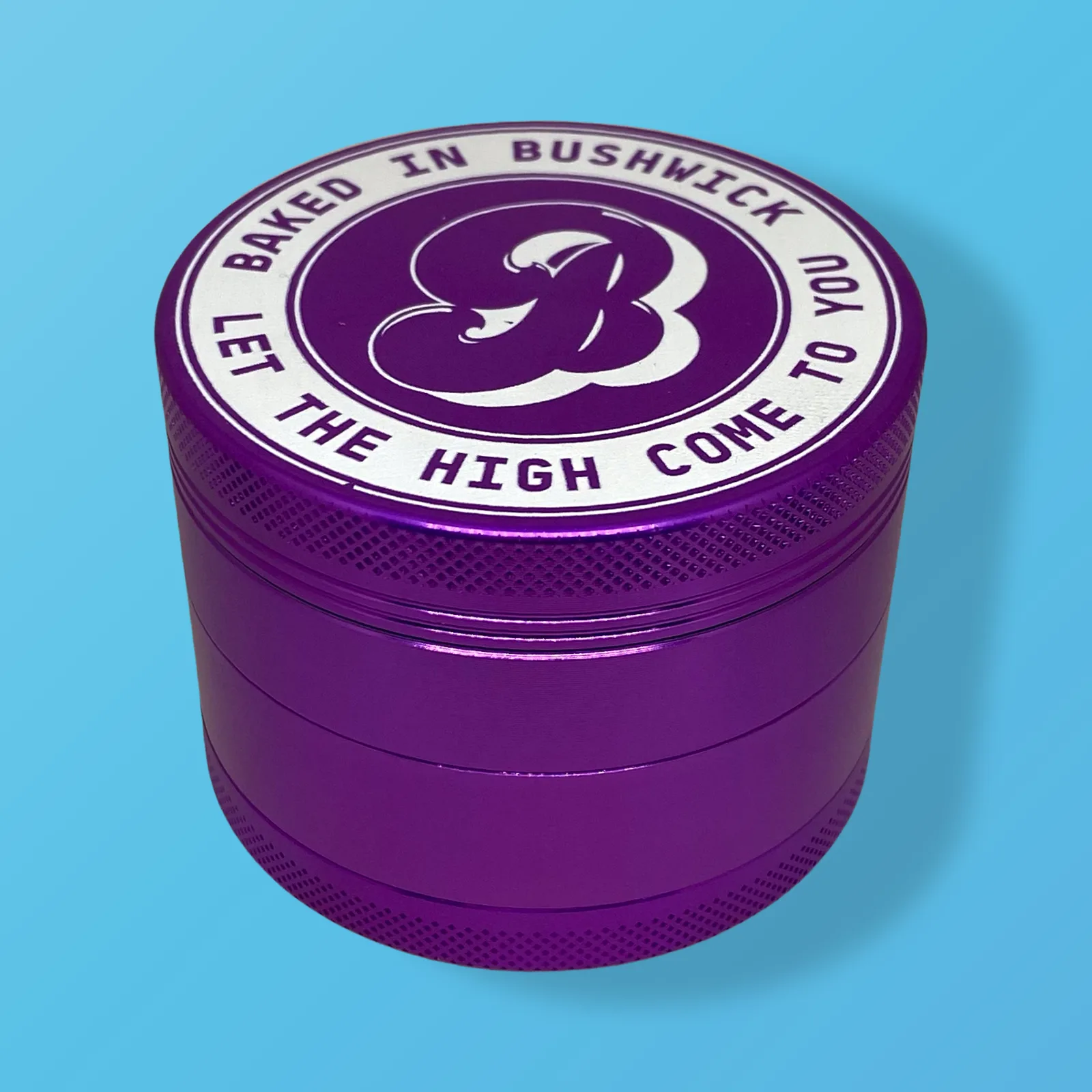 Baked in Bushwick Purple Aluminum Grinder – 63mm 4-piece with Keif Catcher and mesh screen compartment.
