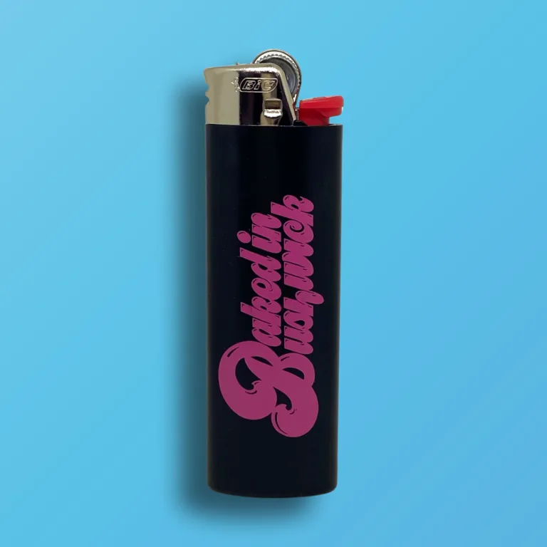 Black BIC Maxi lighter with hot pink Baked In Bushwick logo printed on one side, custom cannabis accessory