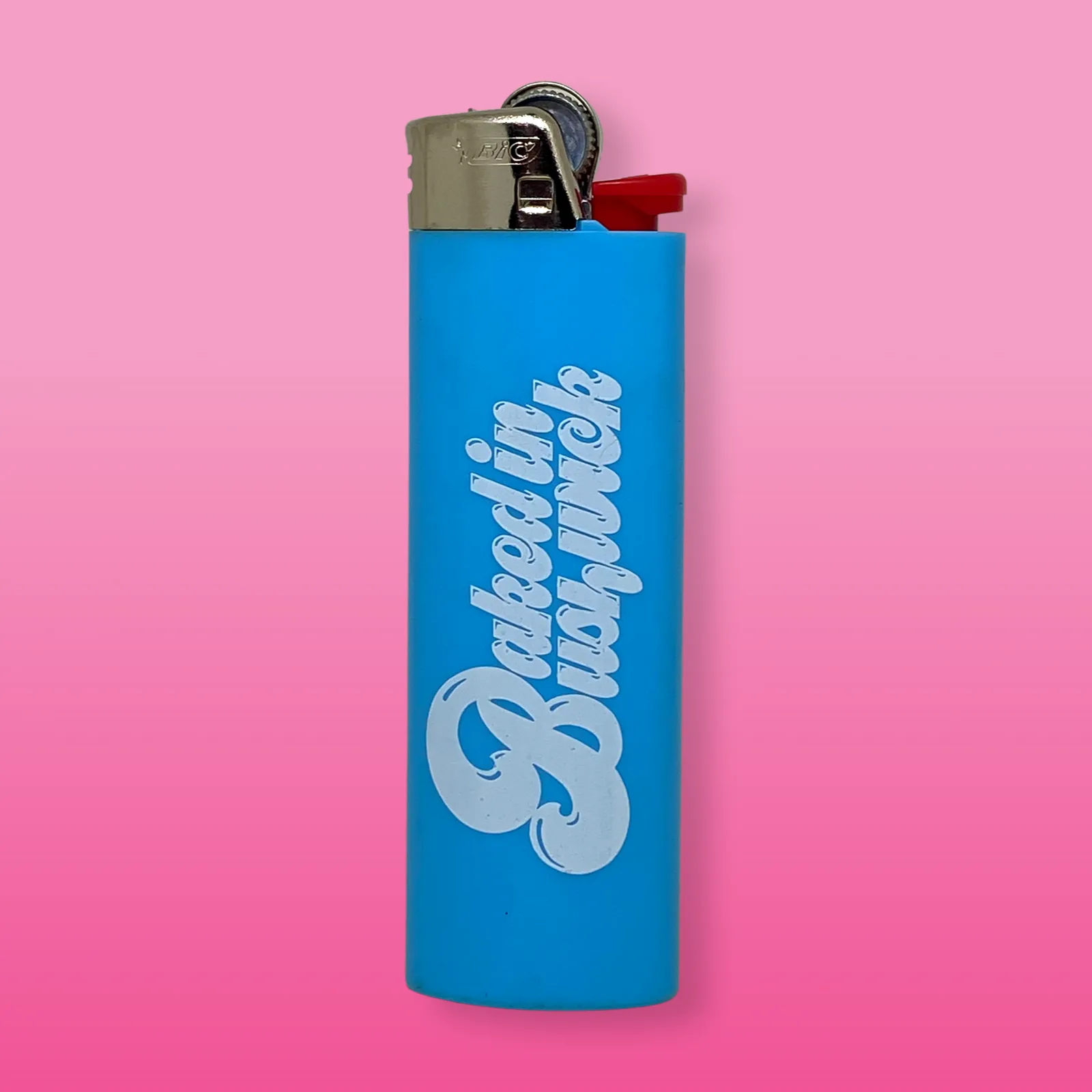Blue Baked in Bushwick-branded lighter with bold white logo design on compact refillable torch